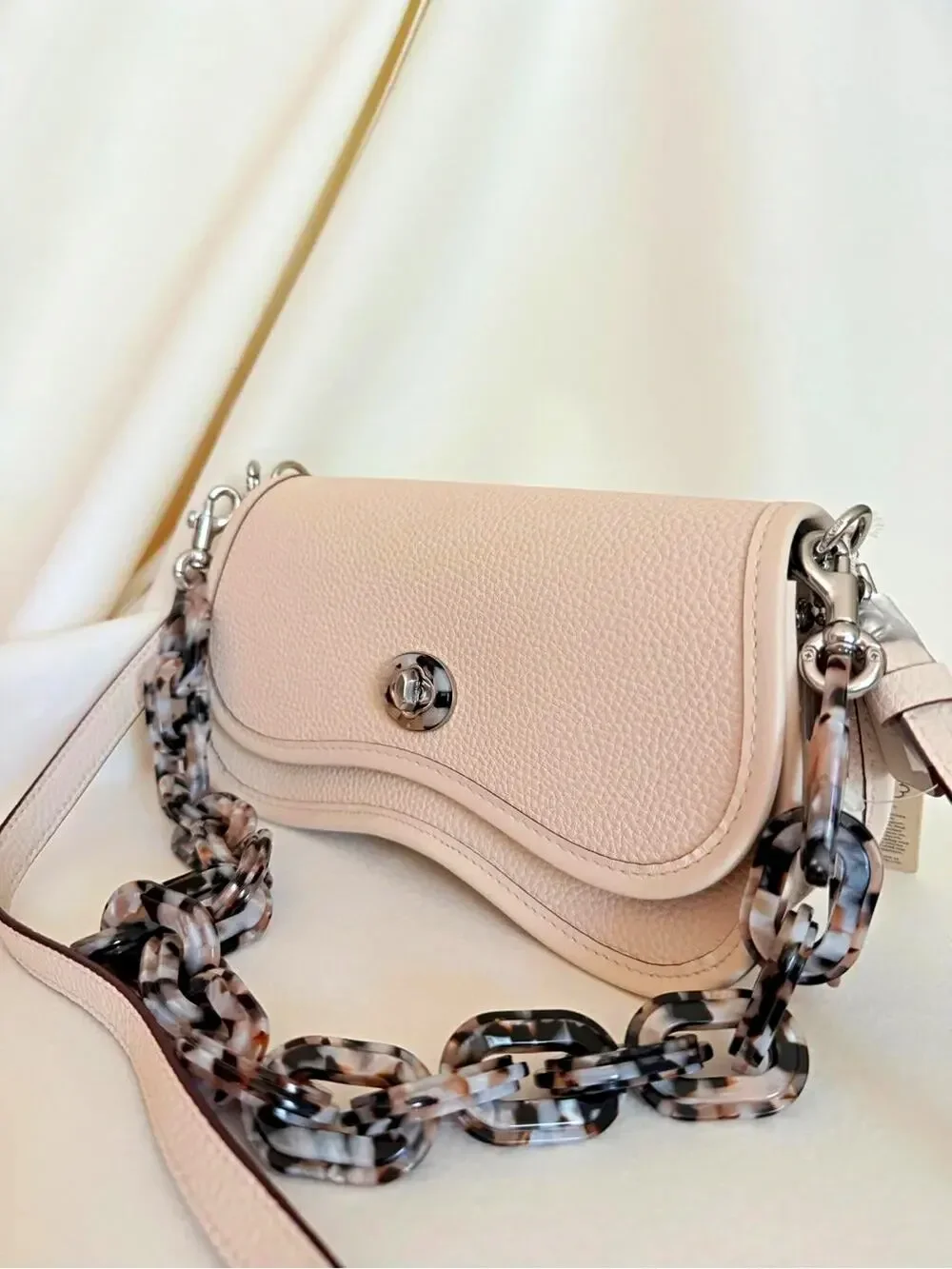Beige Pebbled Crescent Crossbody Bag Silver Turn Lock Tortoise Chain Strap